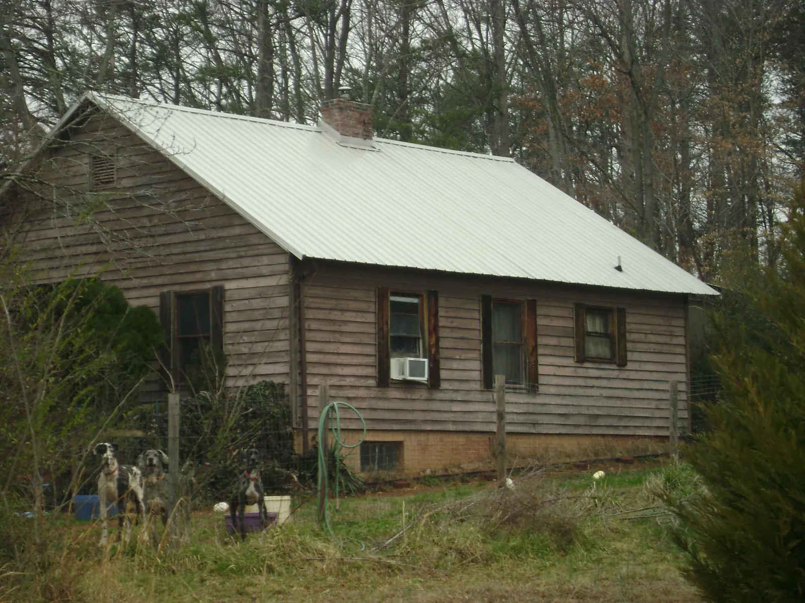 White metal roof on an old wood sided farmhouse, from a Metal Roof Installation job in Pelzer